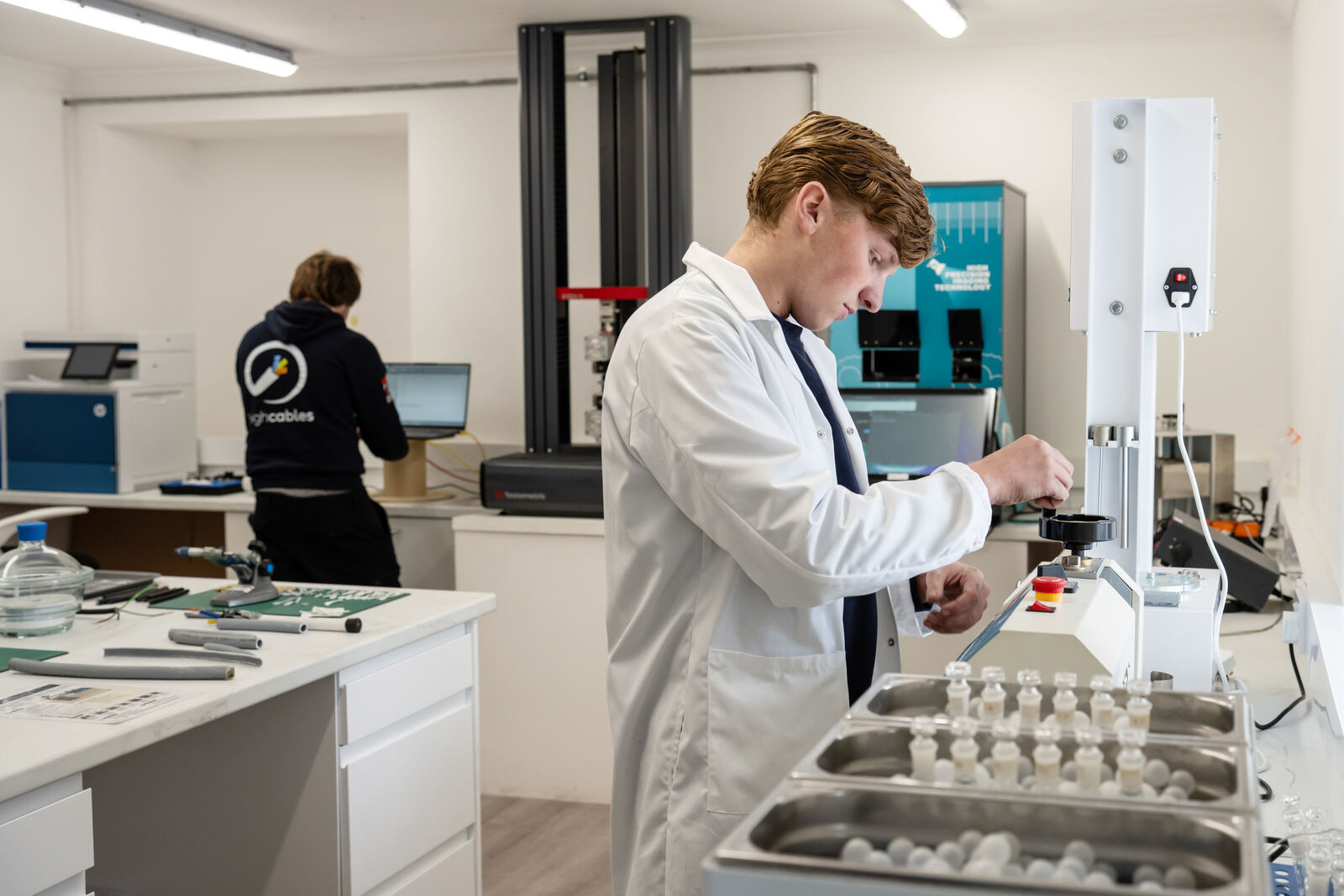 Engineer testing cable samples in the lab